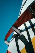 Abstract geometric shapes rising toward a bright horizon symbolizing progress and longevity.