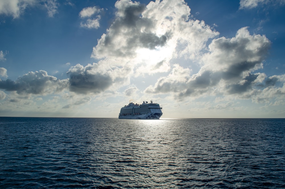 white cruise ship on blue sea under white and blue sky