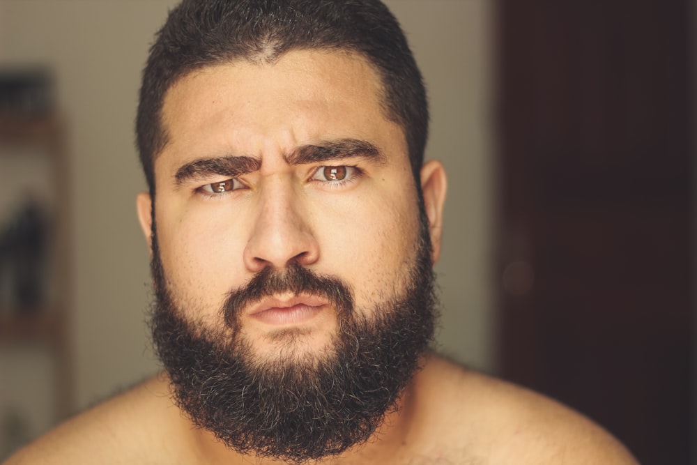 topless man with black beard