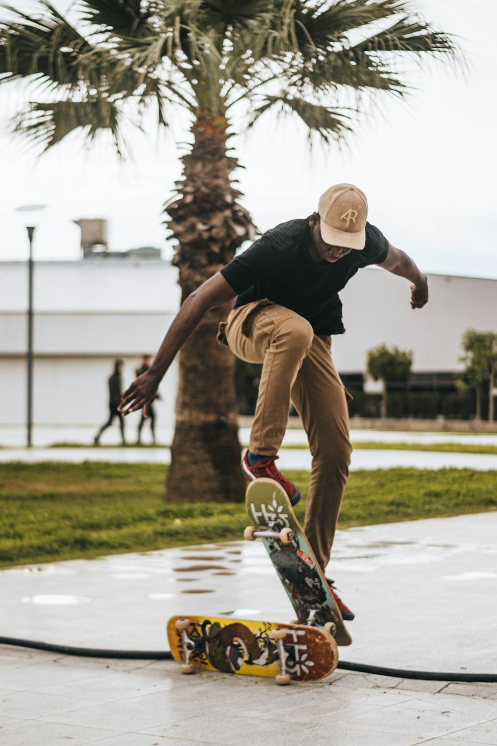 man wearing black crew-neck t-shirt skateboarding on pathway