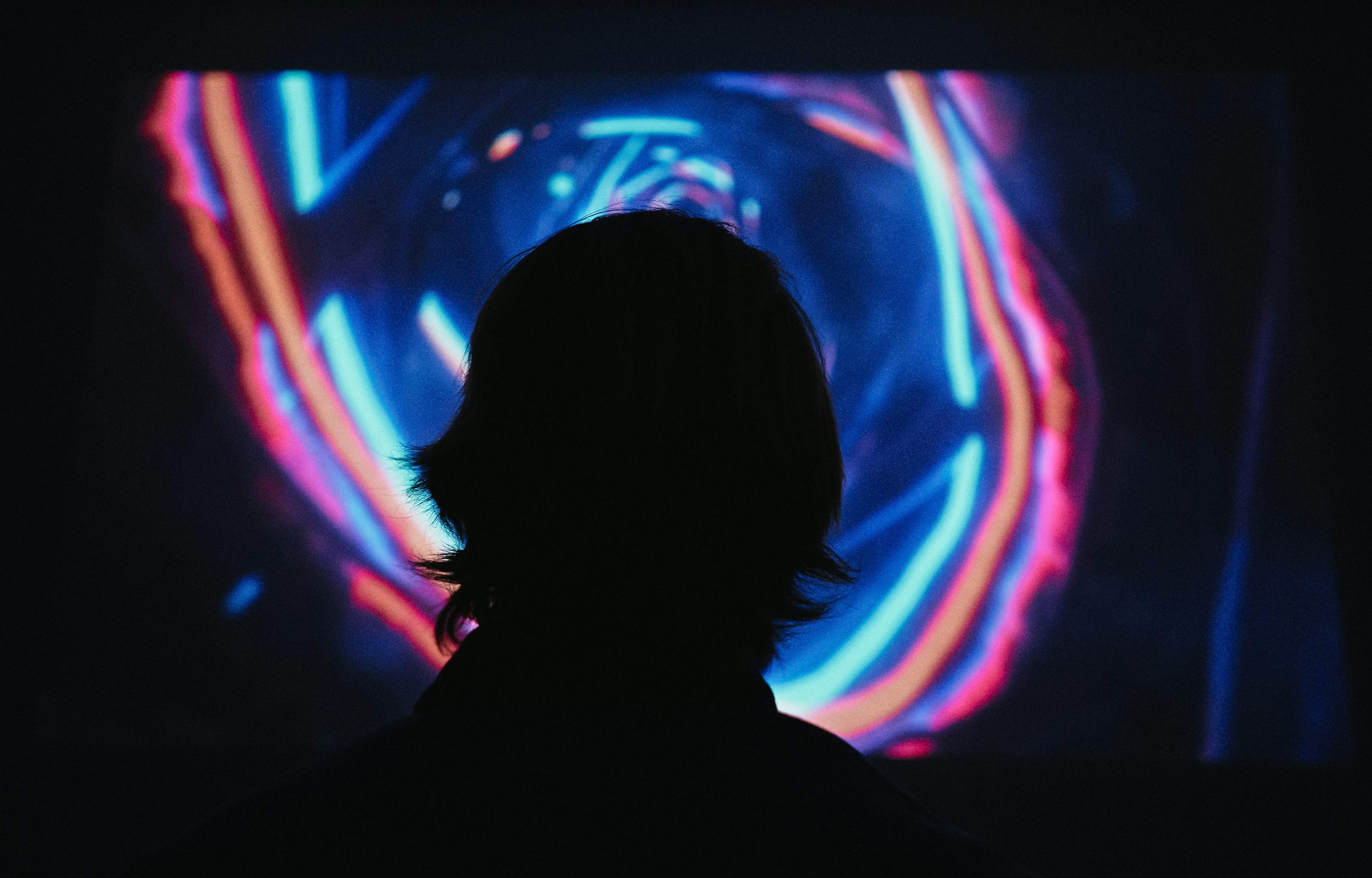 A portrait of a person's face with intricate, glowing lines of digital data projected onto their skin, representing the personalization and privacy concerns of AI in marketing.