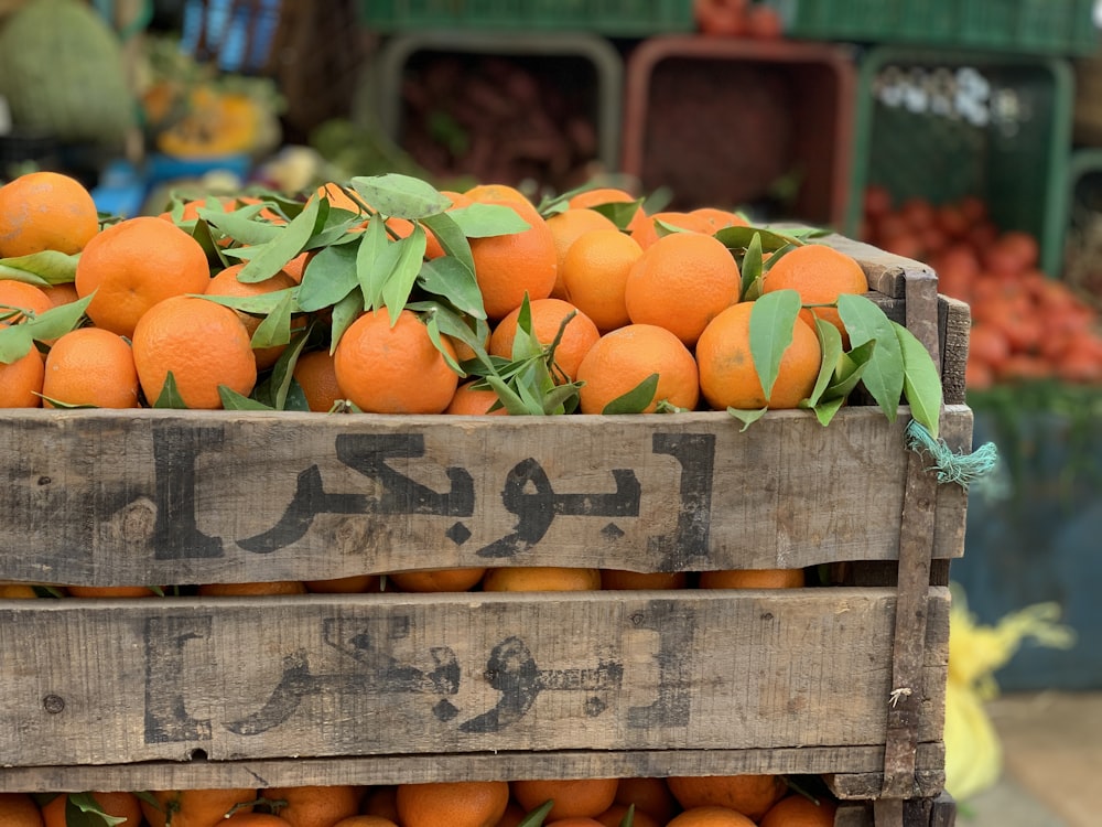 wooden crate filled with orange fruits