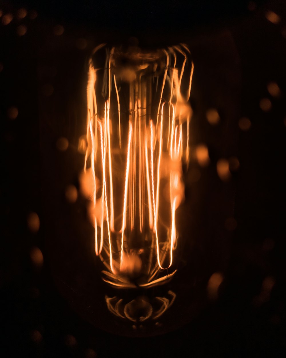 macro photography of lighted orange bulb