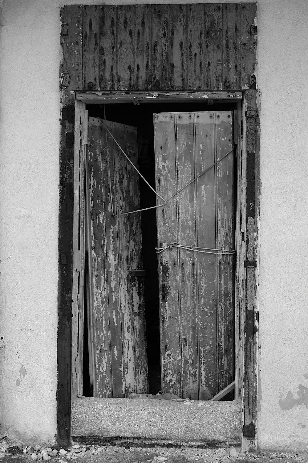 grayscale photography of destroyed wooden door