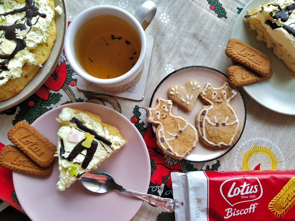 a table topped with plates of food and a cup of tea