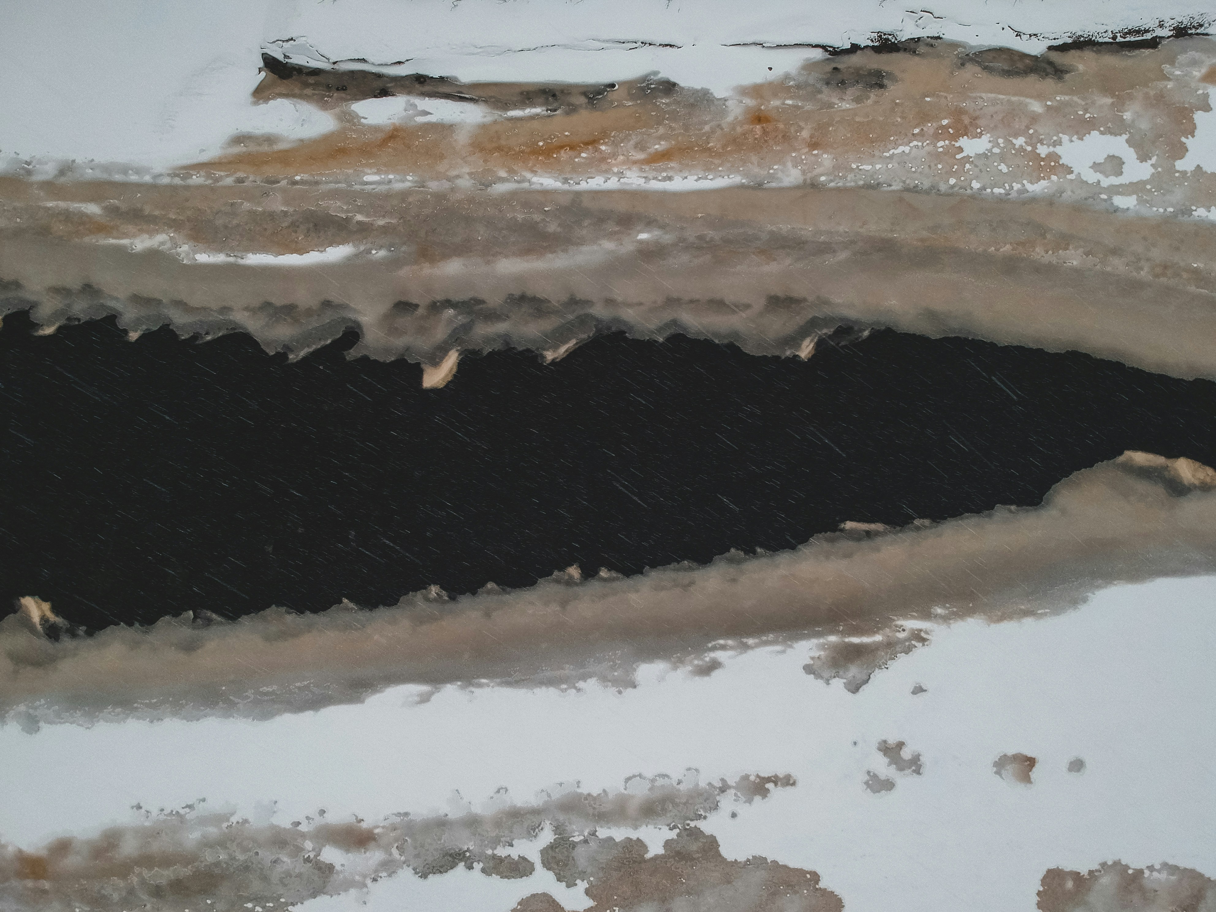 an aerial view of a snow covered area
