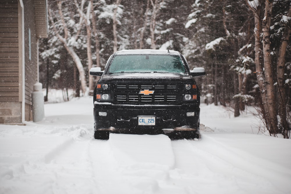 a black truck is parked in the snow