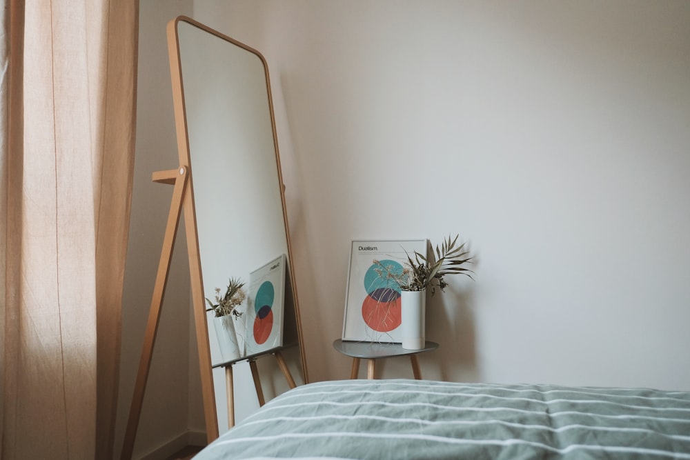 green plant beside white and brown easel