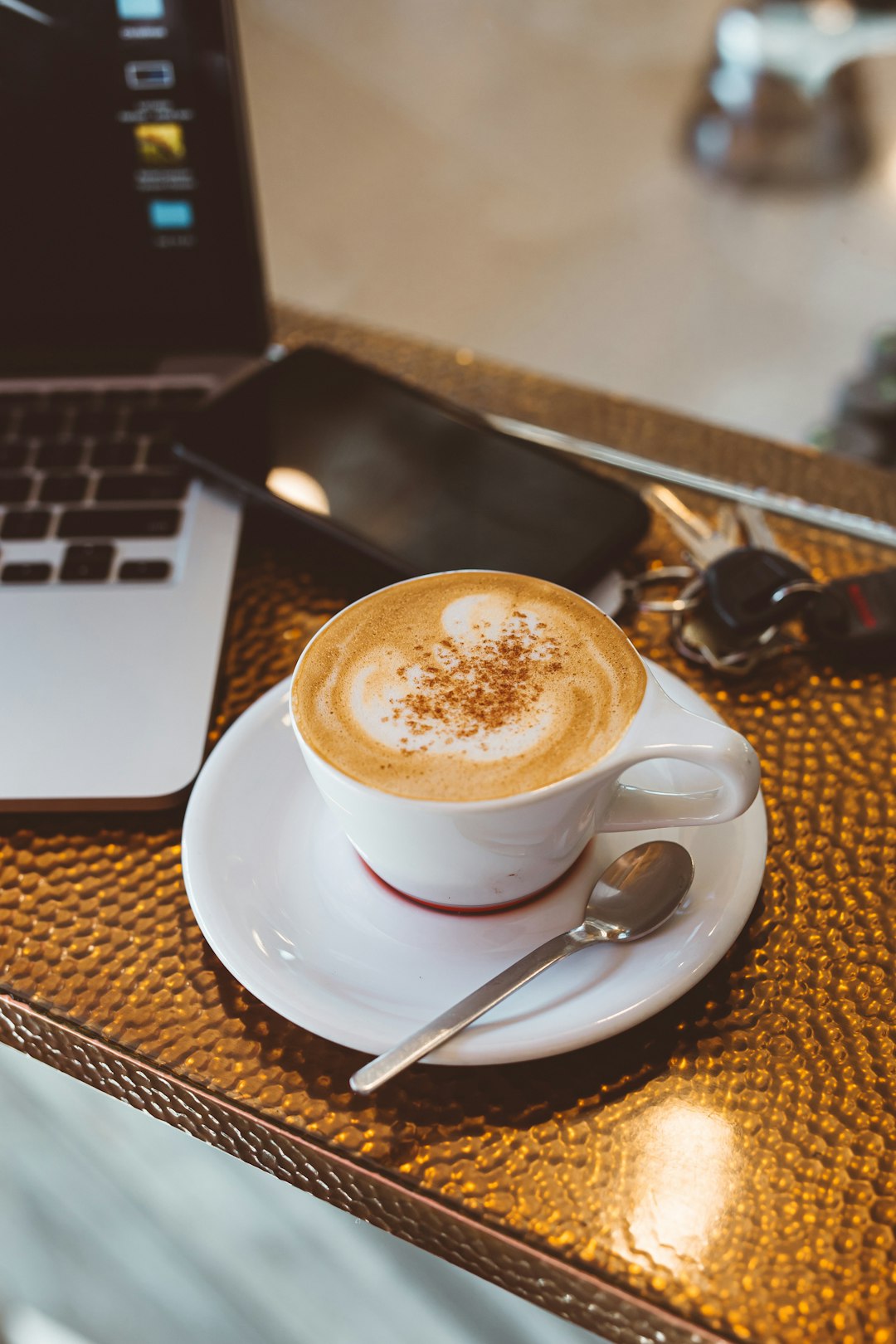 white ceramic mug beside the laptop