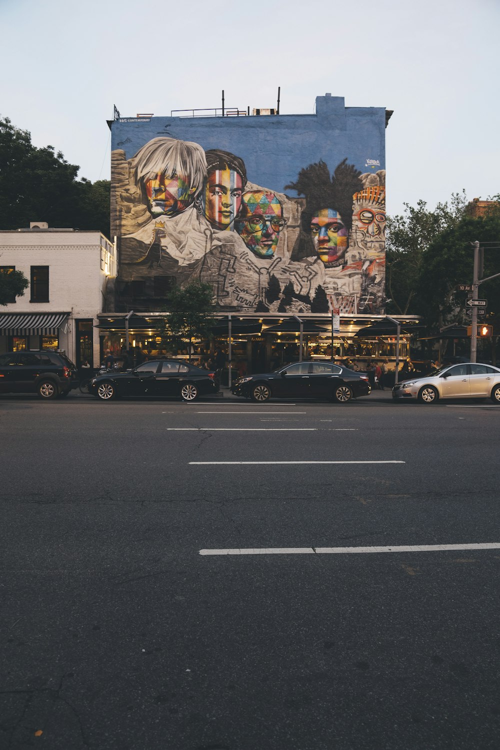 vehicles parked in front of graffiti