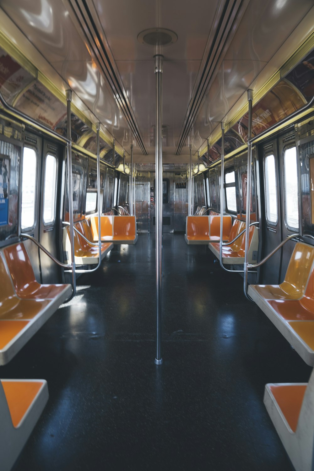 an empty train car with orange seats