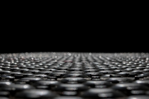Close-up of a single sheet of graphene on a futuristic industrial background.