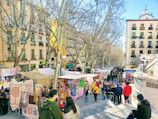A vibrant street market bustling with colorful stalls under a deep blue sky