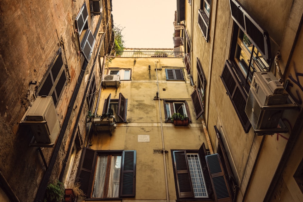 low-angle photography of yellow high-rise buildings