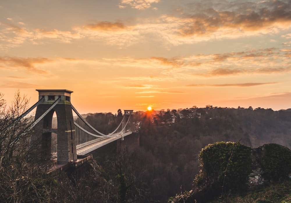 arch bridge under orange and gray sky