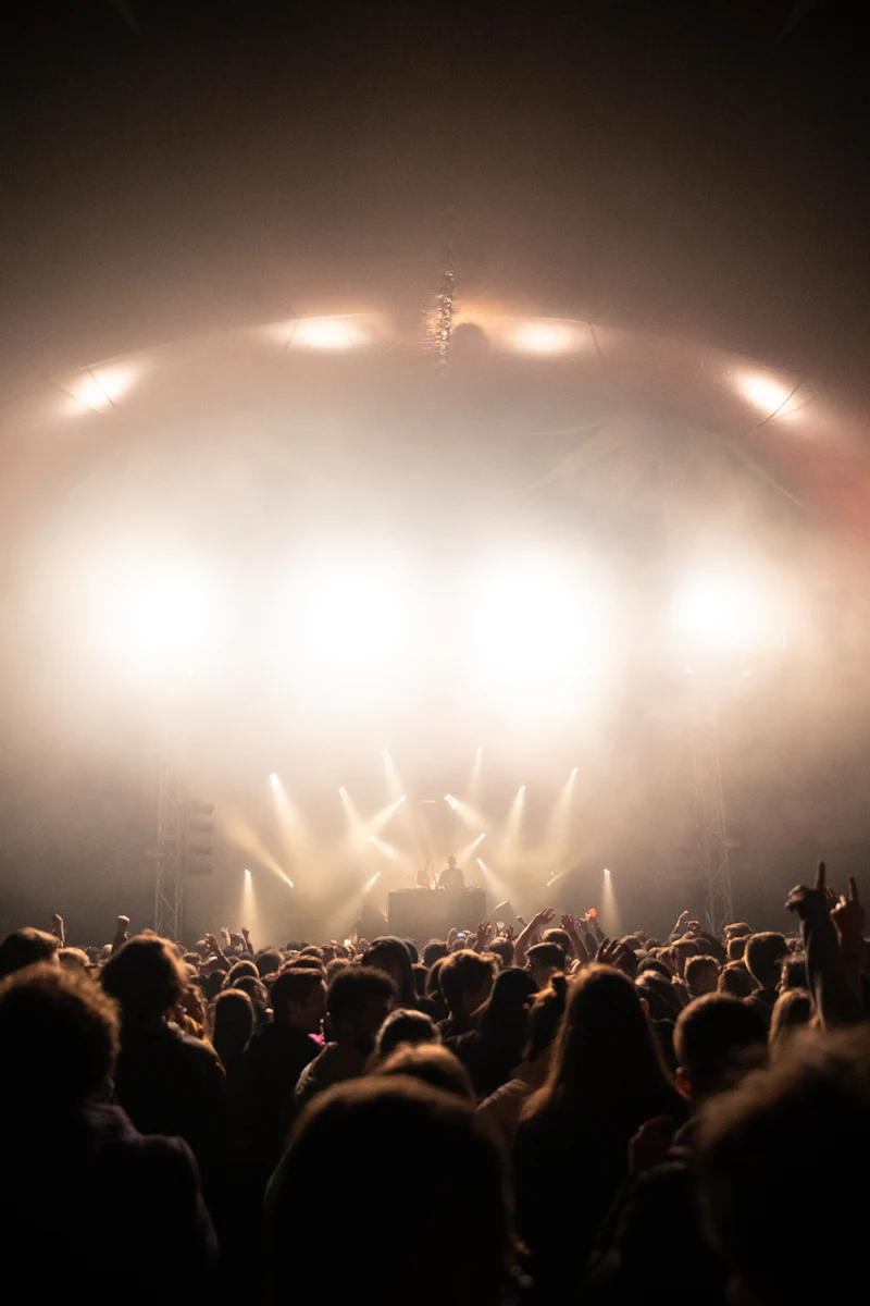 An audience in front of a lit stage