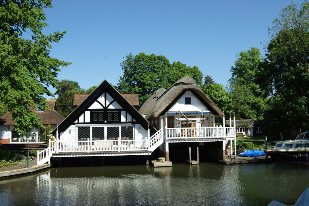 white and brown wooden cottages above a body of water