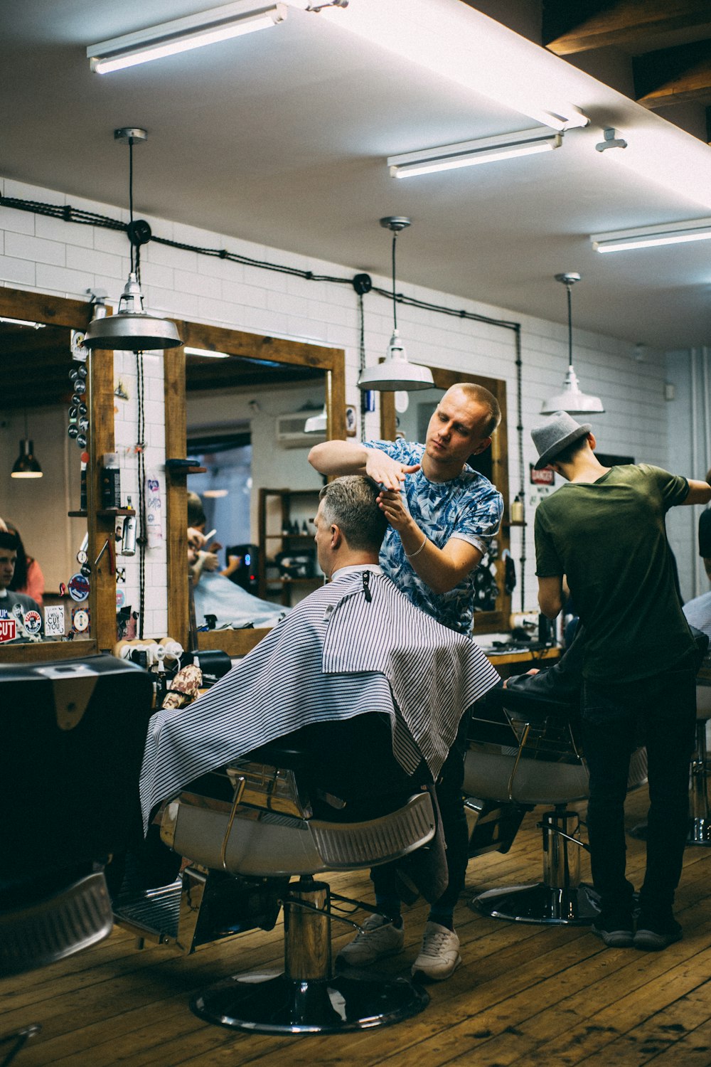 man cutting person's hair