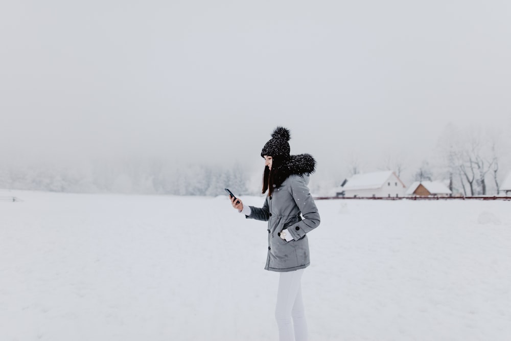 shallow focus photo of person in gray hoodie wearing black bobble hat