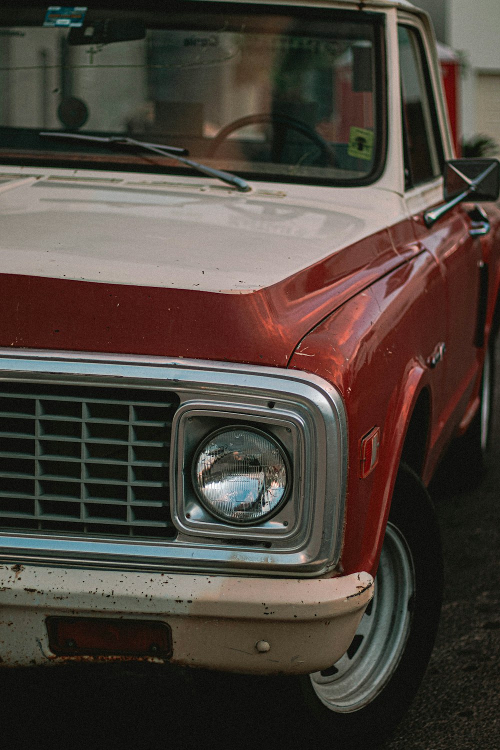 shallow focus photo of red single-cab truck