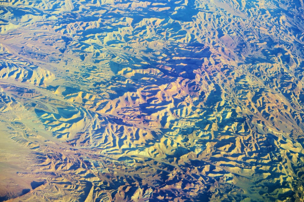 an aerial view of a mountain range from an airplane