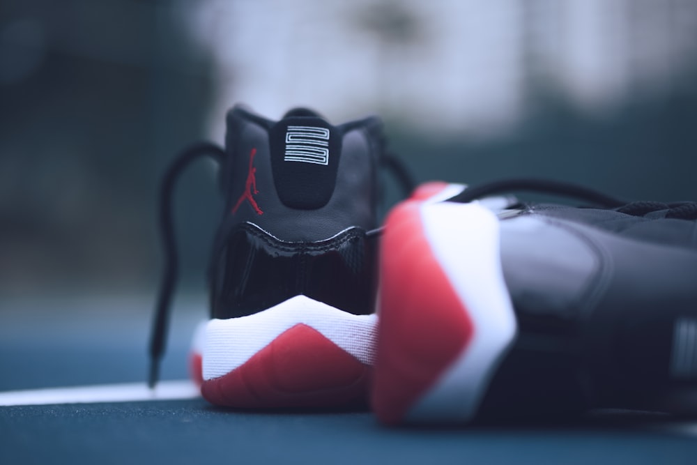shallow focus photo of pair of bred Air Jordan 11's