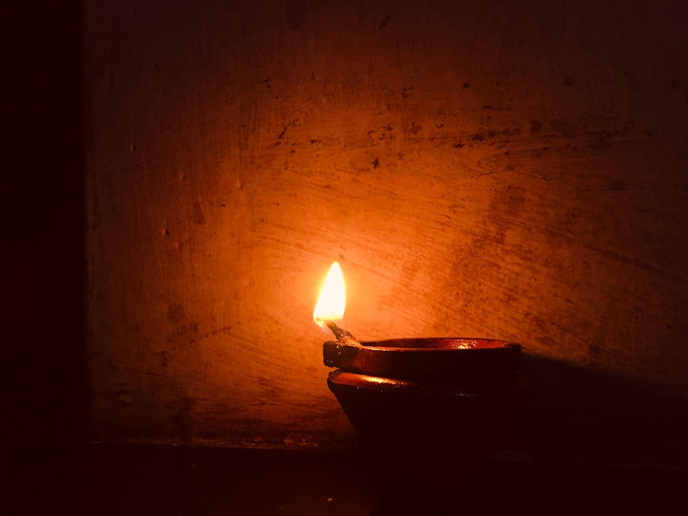 oil lamp beside wall