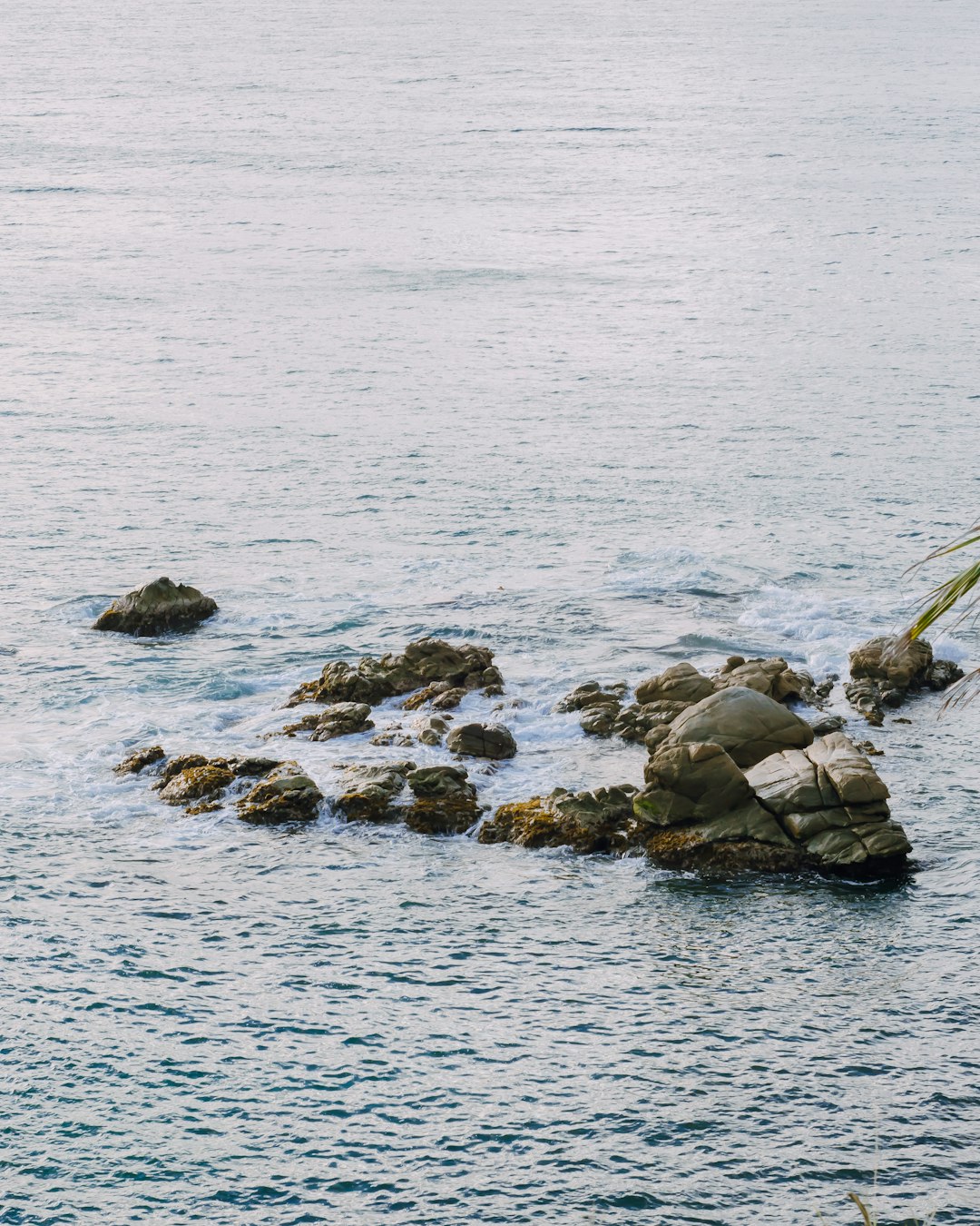 gray rock formations on body of water