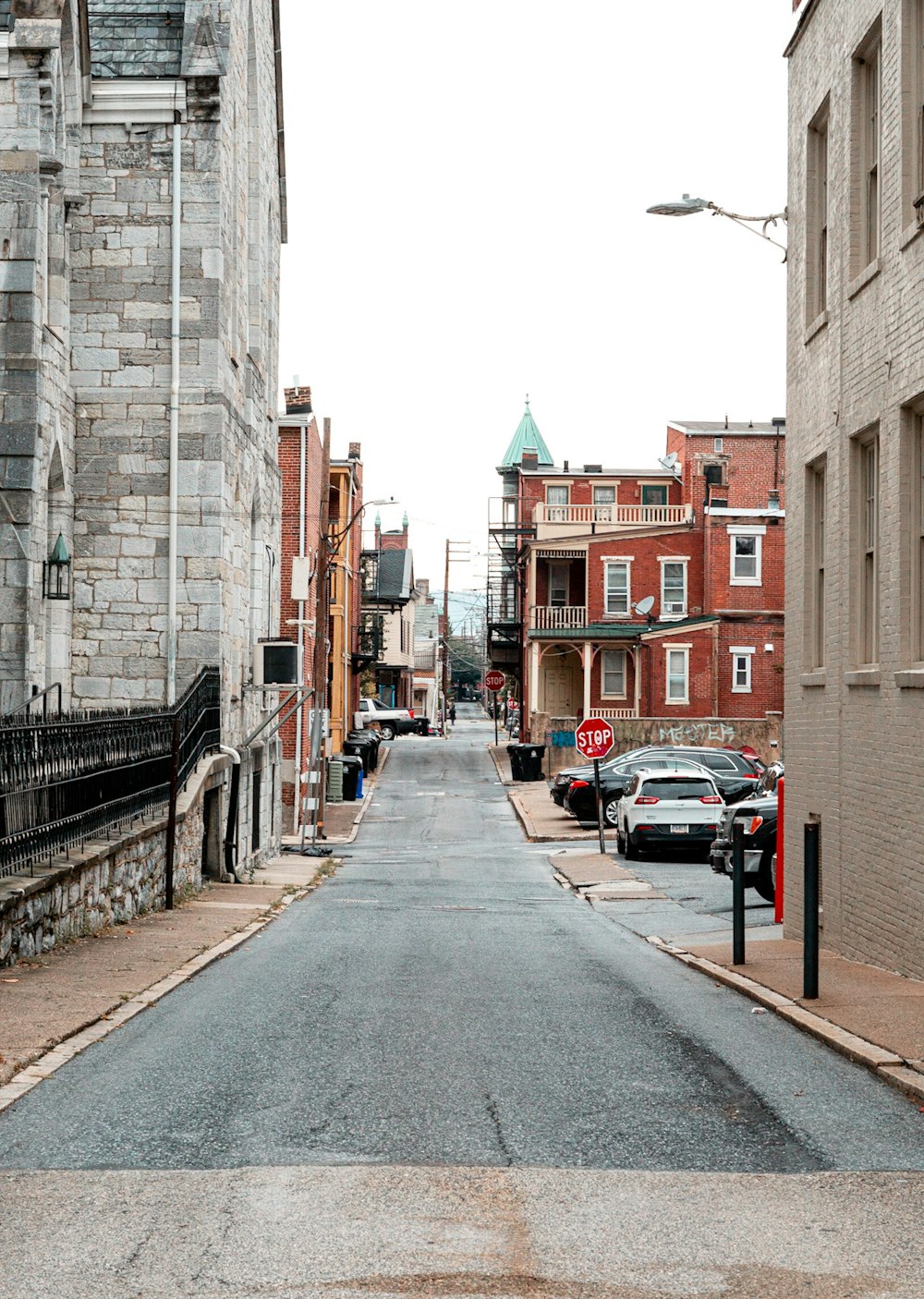 cars parked beside brown building