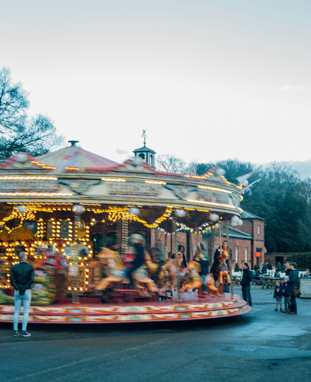 time-lapse photography of a spinning carousel under a calm blue sky