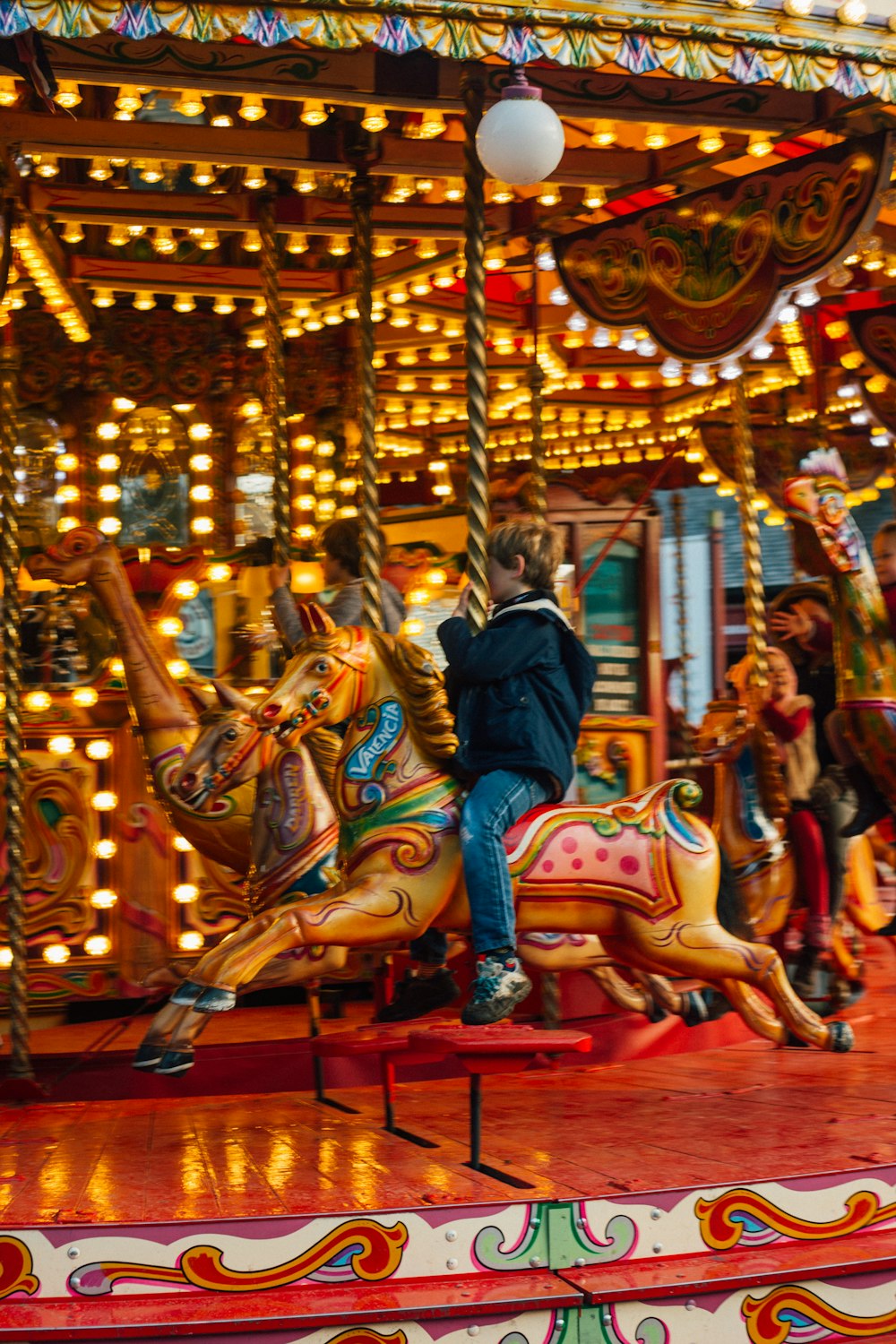 children riding merry-go-round