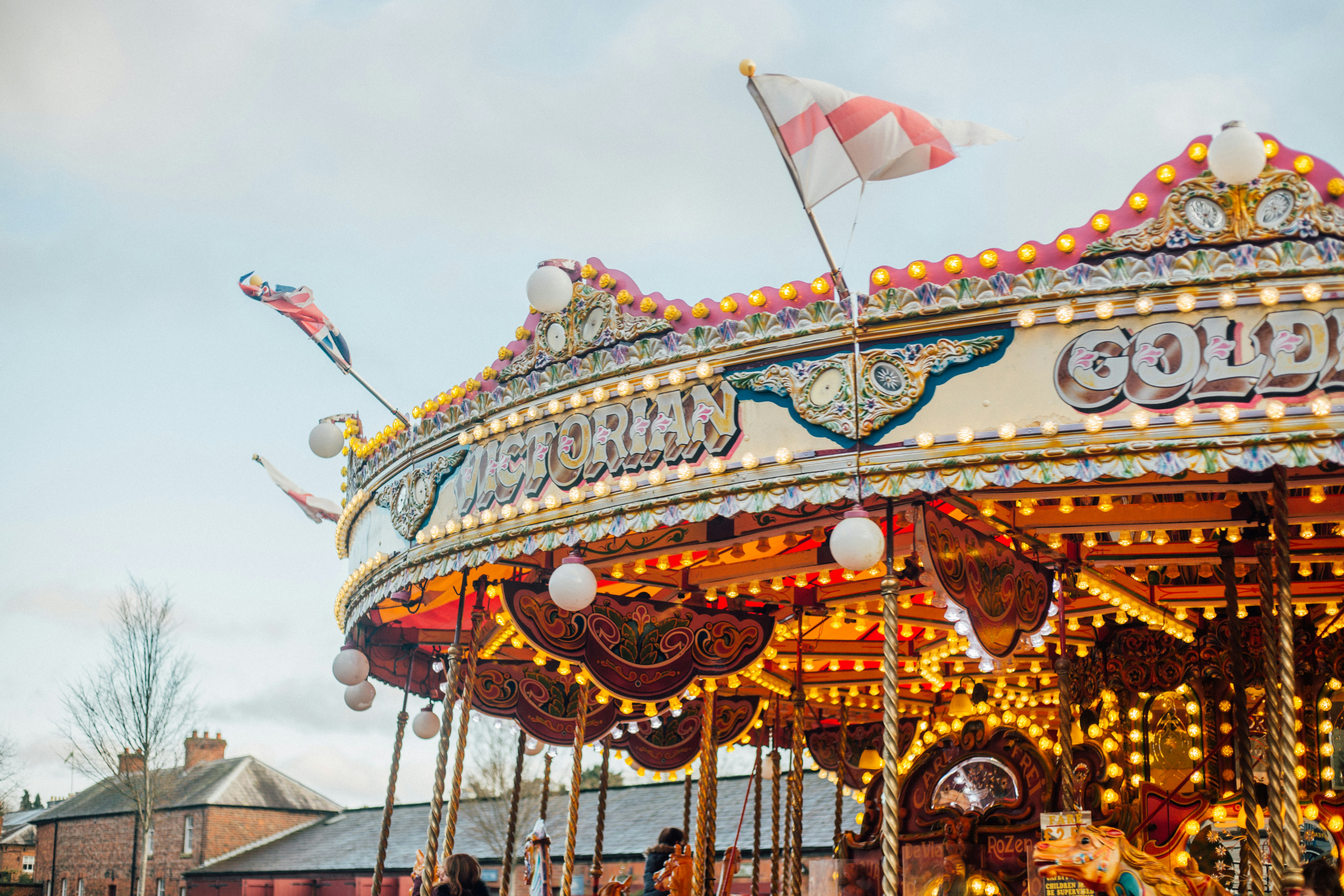 children riding merry-go-round during day victorian teams background