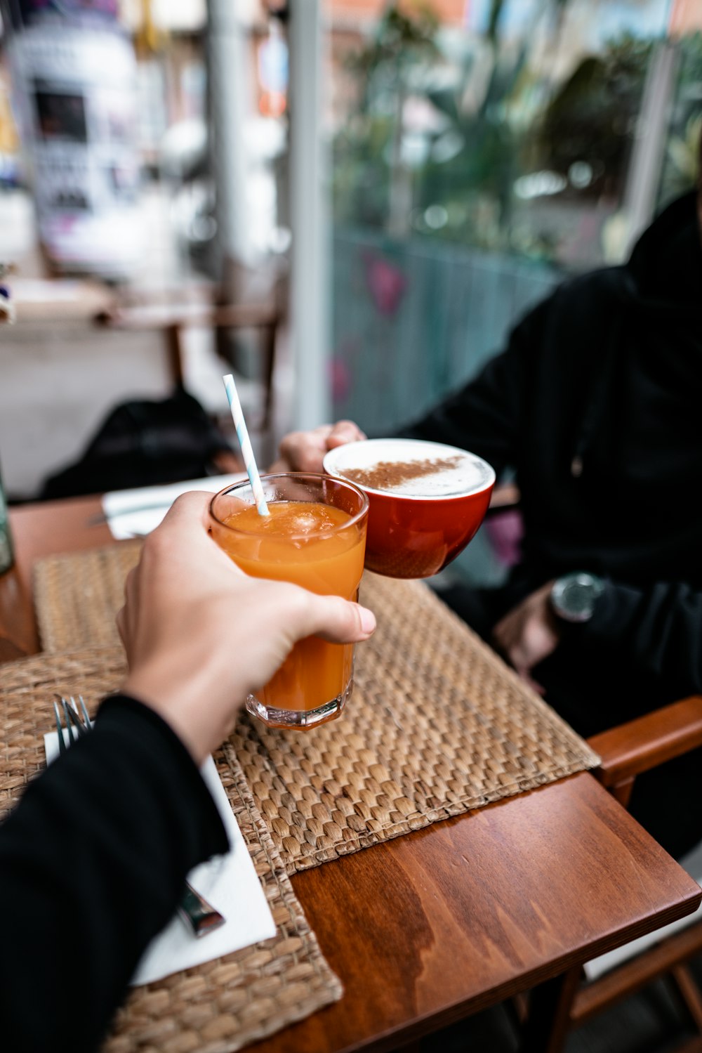 person holding glass of juice