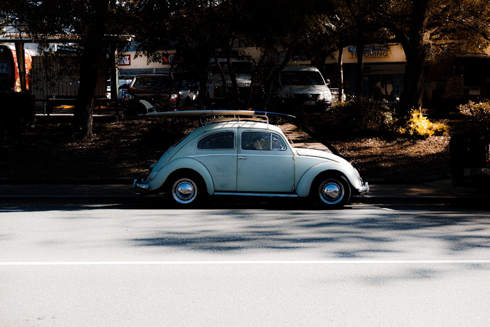 white Volkswagen Beetle parked on roadside