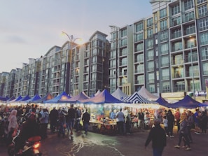 A lively street market in Tel Aviv bustling with colorful stalls and diverse crowds.