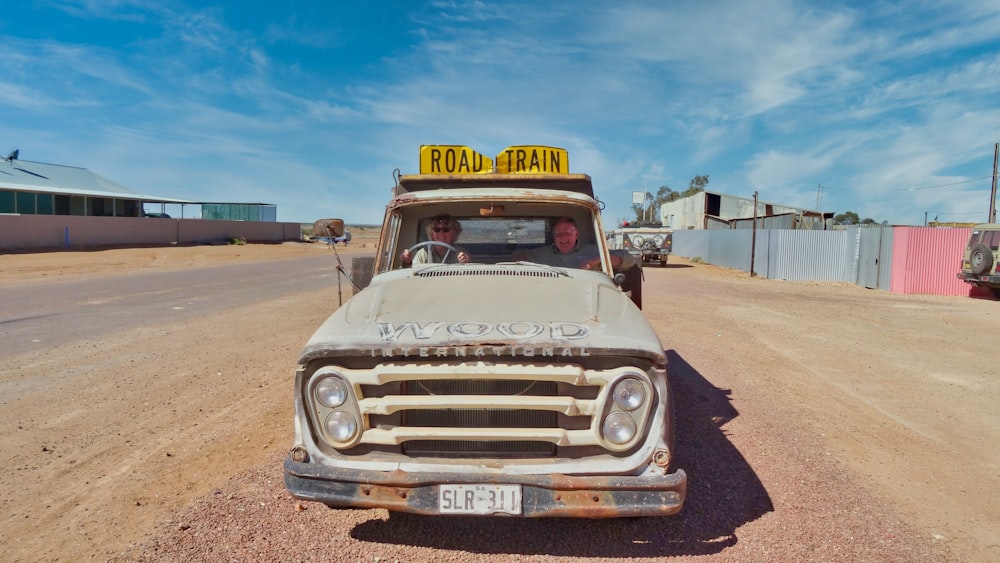 white vehicle on dirt road