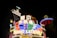 Bright neon signs in multiple colors illuminate the night, prominently displaying the name 'Casino Lisboa' alongside signage in Chinese characters. The lights form intricate patterns and vibrant displays, creating a lively and energetic atmosphere.