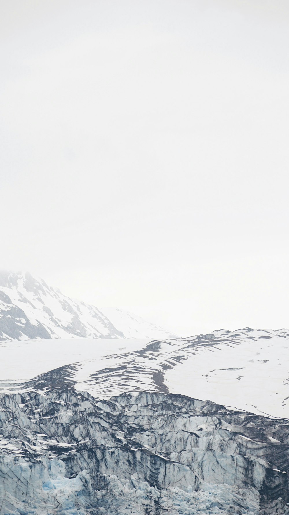 a man standing on top of a snow covered mountain