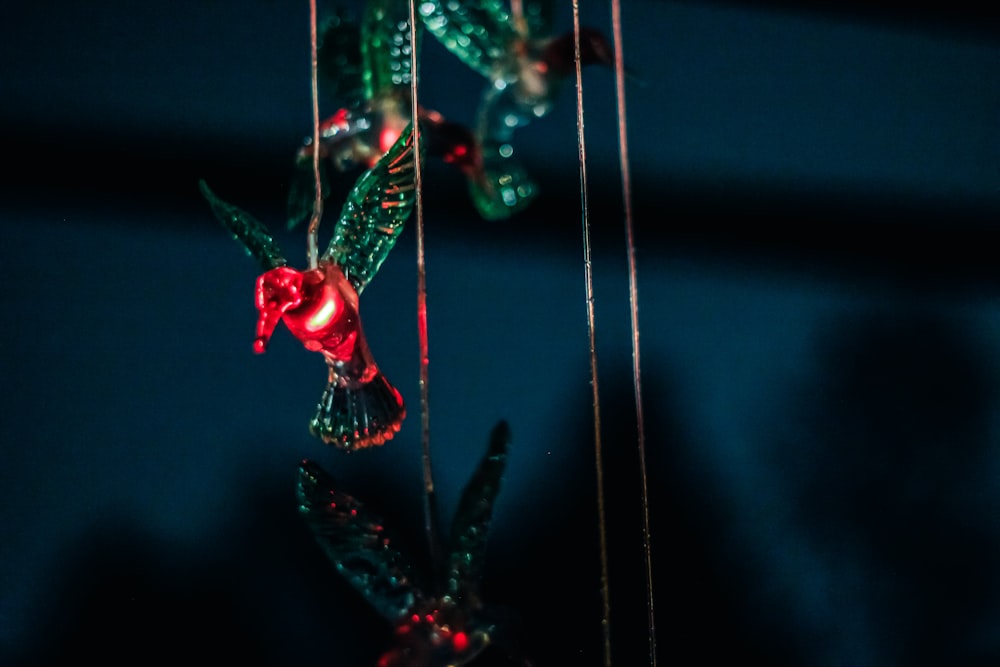 a couple of glass birds hanging from strings