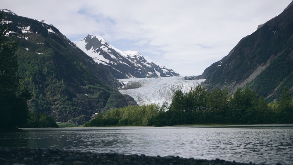 body of water and mountains during day