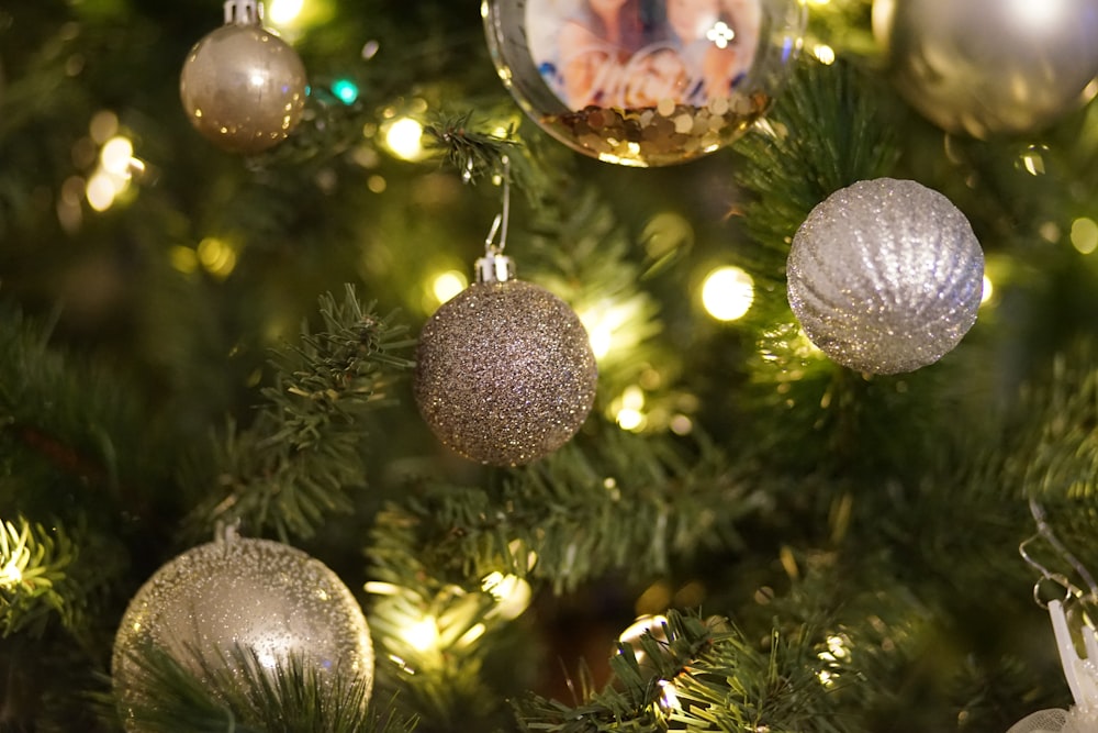 macro photography of silver bauble on Christmas tree