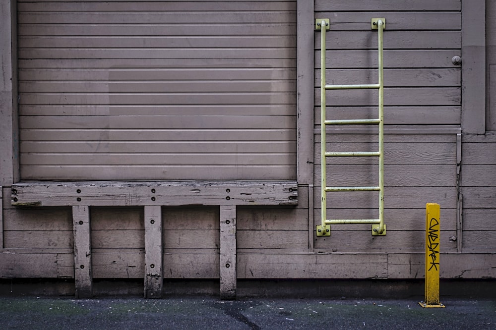 green metal ladder on wall