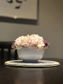 A lavender-toned decorative bowl with intricate 3D printed patterns on a white table.