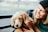 A happy pet owner playing with a cheerful dog in a bright pet shop interior.