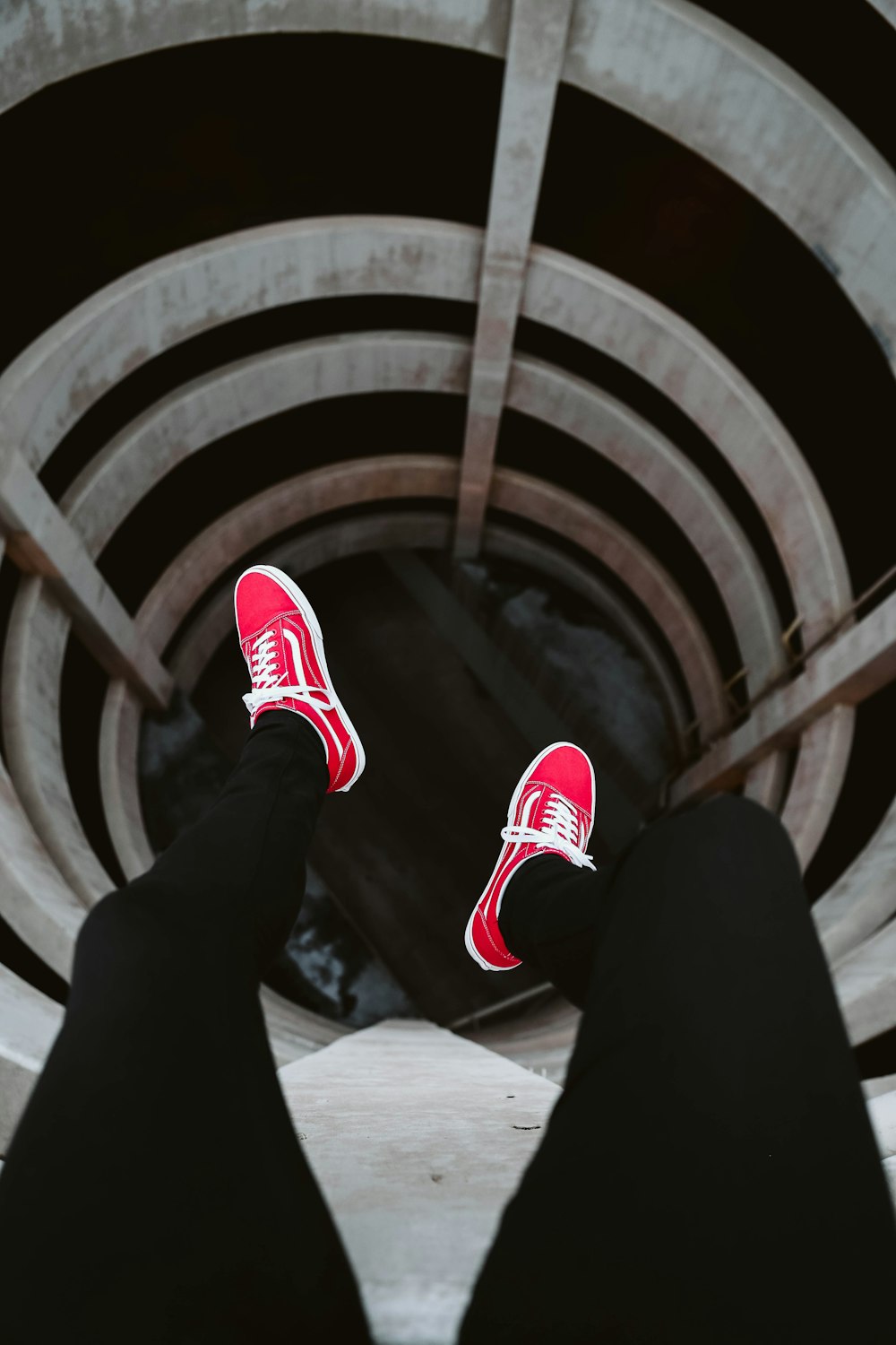 person wearing pair of red Vans low-top sneakers