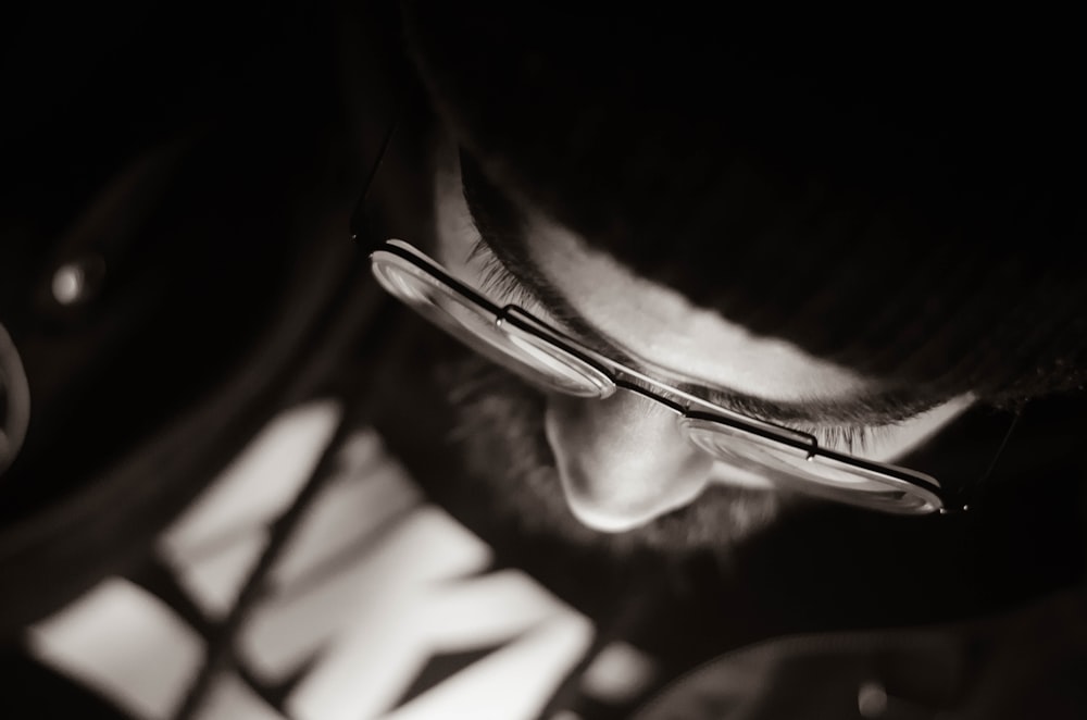 macro photography of person wearing eyeglasses
