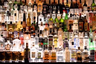 assorted liquor, wines, and whisky on display