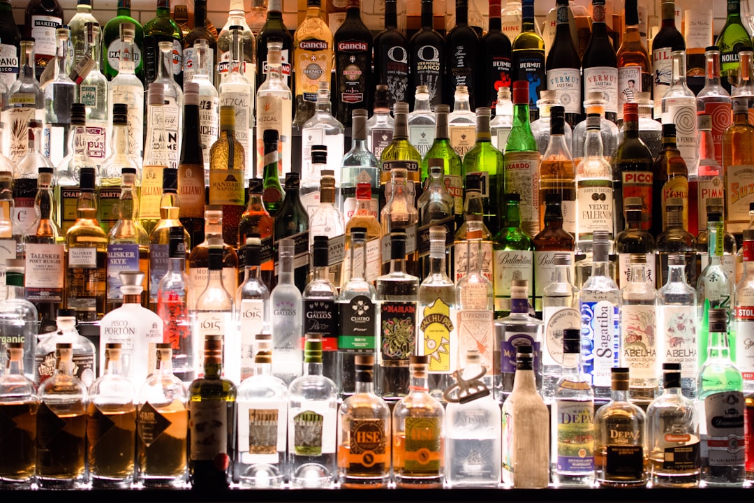 assorted liquor, wines, and whisky on display,