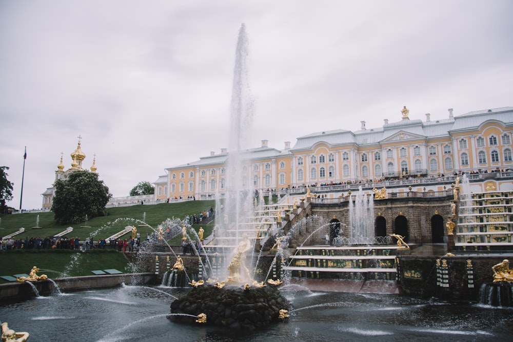 a fountain in front of a large building