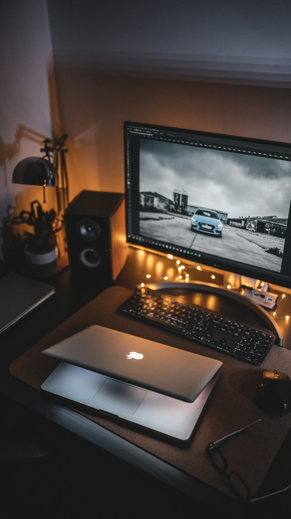 half-opened MacBook in front of monitor